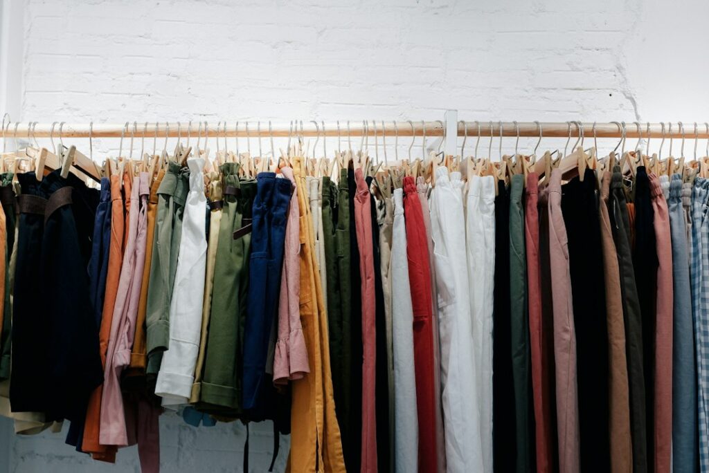 A colourful line of clothes on a rail