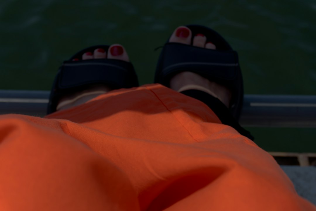Feet in sandals near water