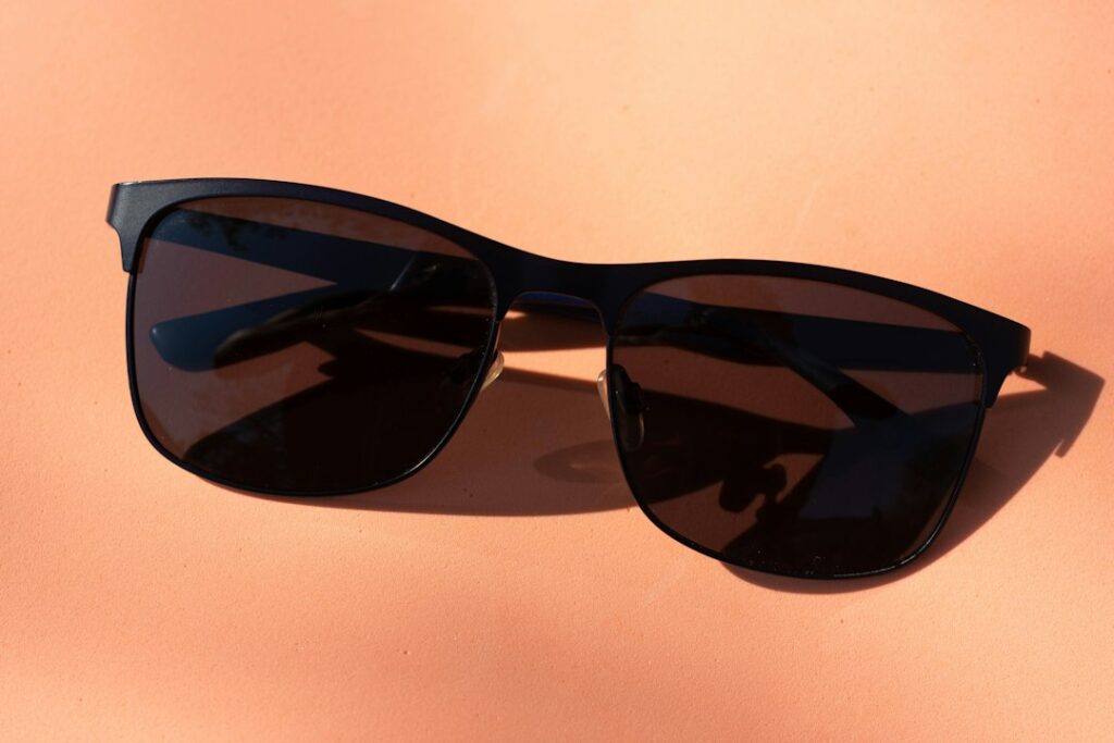 Black-framed sunglasses on a white table