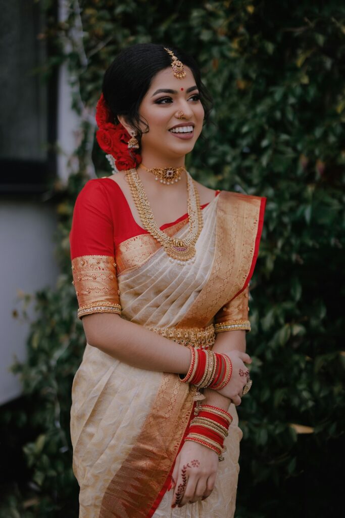 A woman in a white and red sari